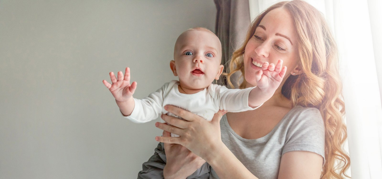 Mother holding her baby after lip and tongue tie treatment in Hamilton