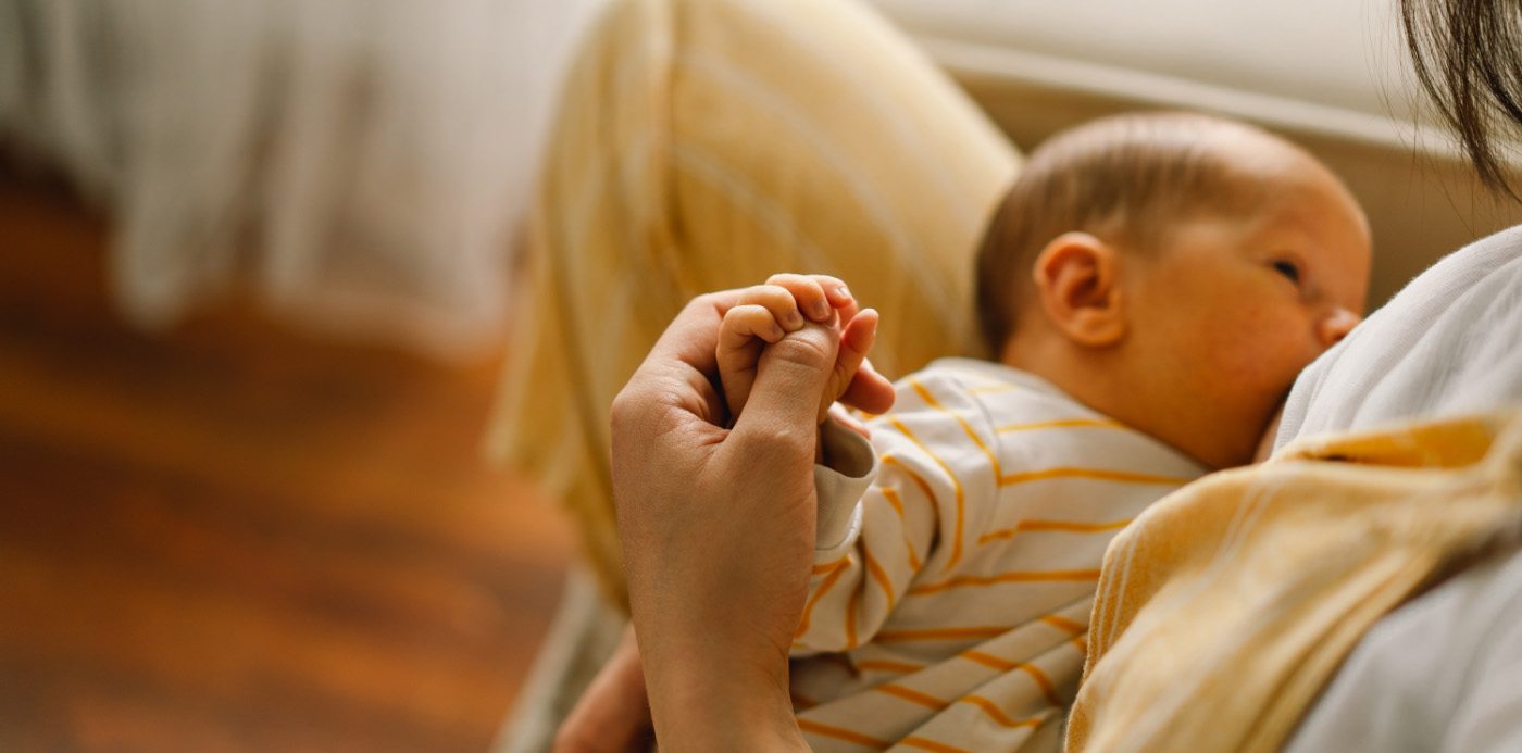 Mother breastfeeding her baby after lip and tongue tie treatment in Hamilton