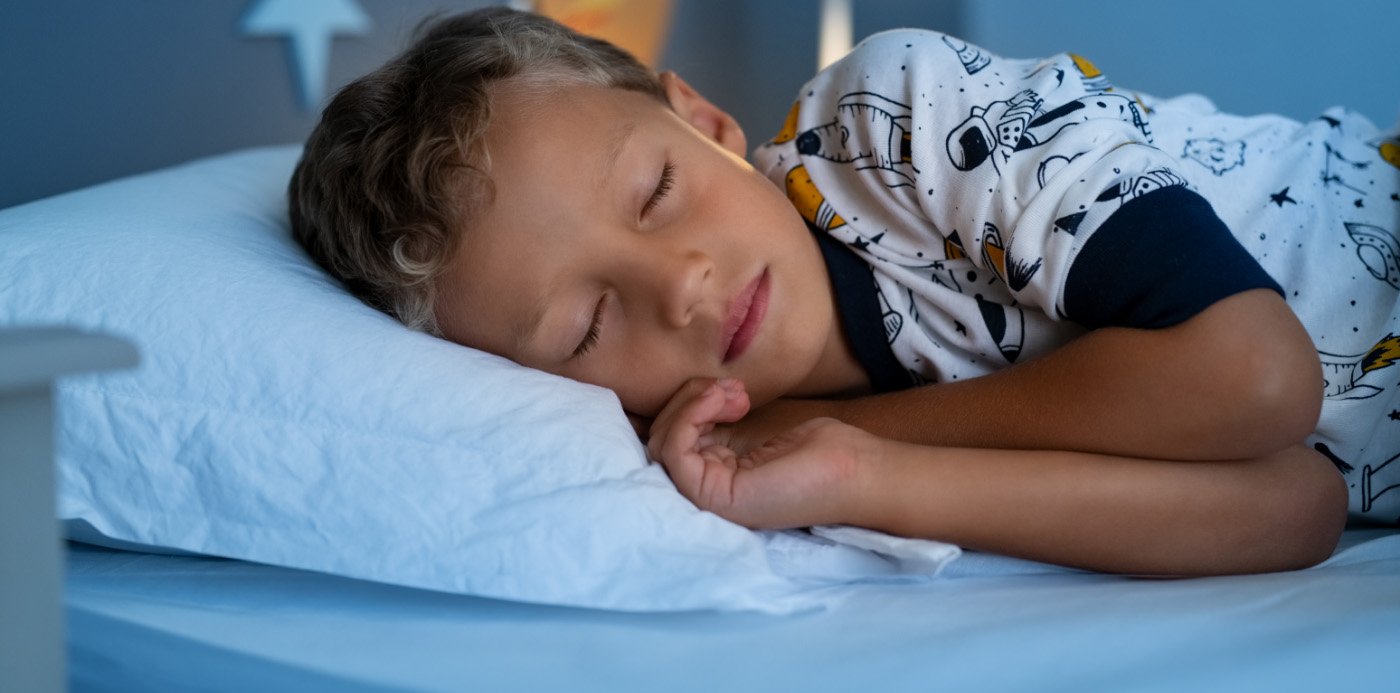 Young boy sleeping soundly on his side