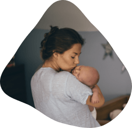 Mother kissing her baby on the head