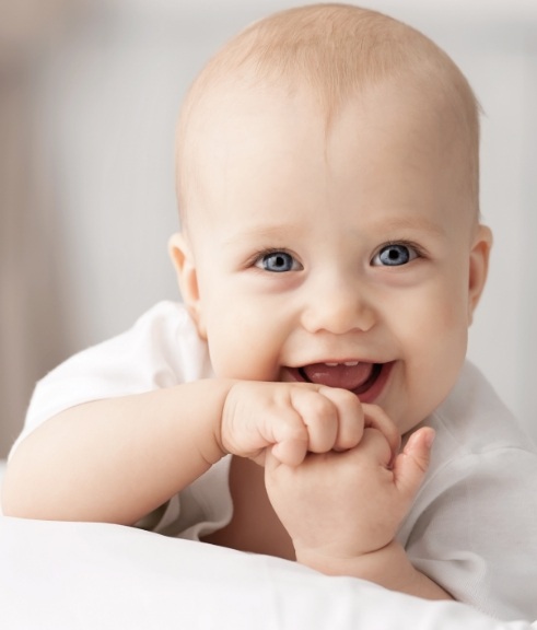 Smiling baby laying on their stomach