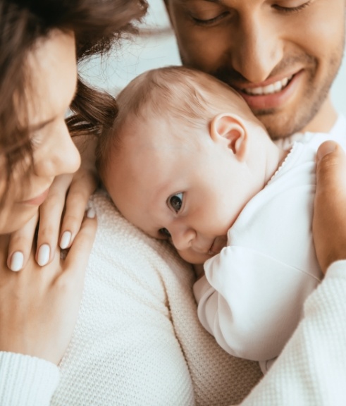 Mother and father holding their baby