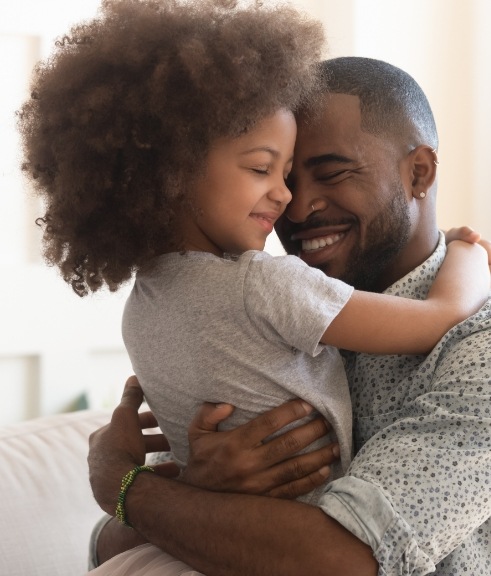 Father hugging his young daughter