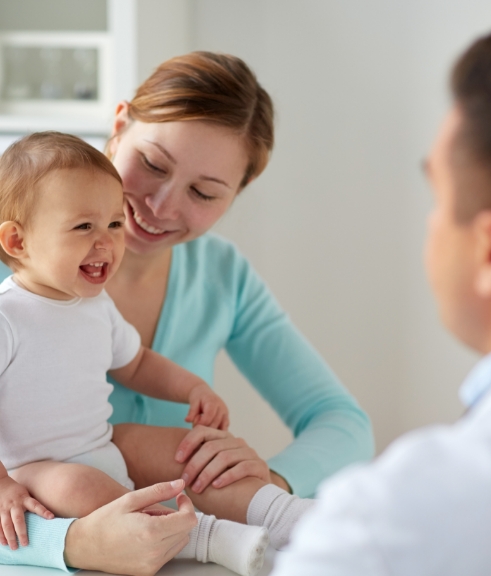 Mother holding her baby during a doctor visit